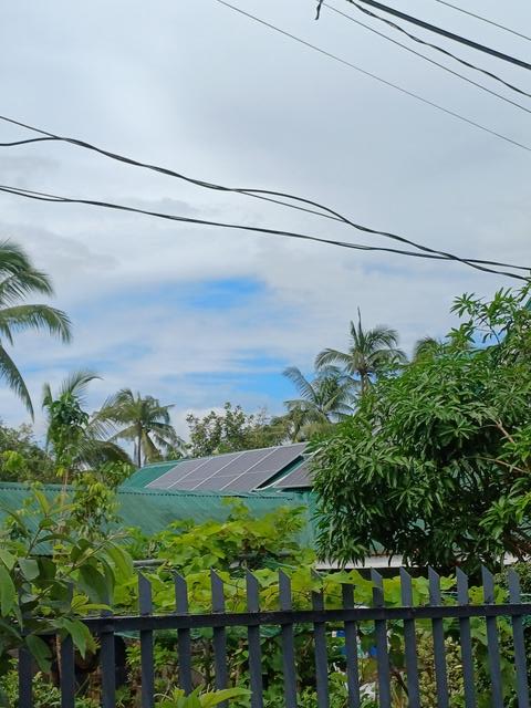 Example rooftop panels supplying an off-grid solar home system